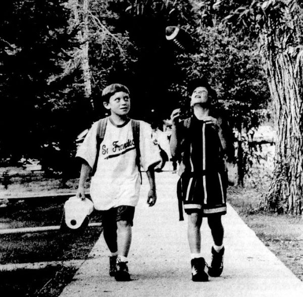 Two boys walk to school on the first day of the school year.
