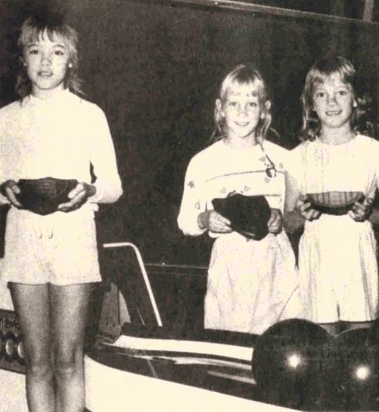 Three girls pose with their bowling awards