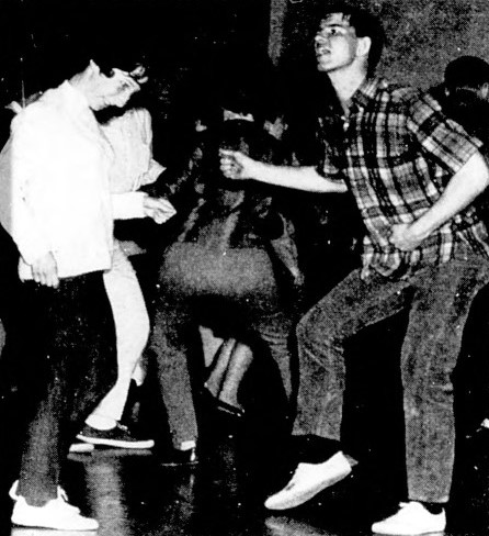 Two young people dance.