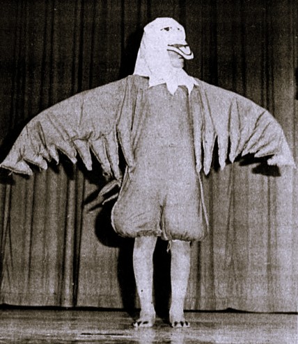 An actor poses on stage in a bald eagle costume