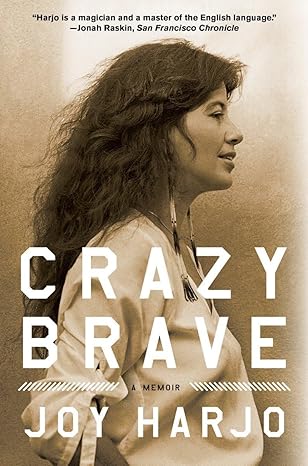 Cover art for Crazy Brave. Sepia tone photograph of a profile of Joy Harjo wearing a white shirt, long beaded earrings, and her hair is down.
