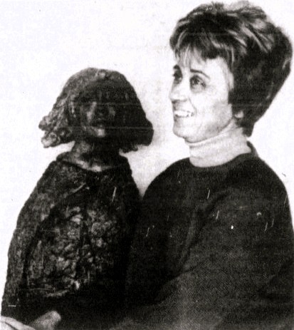 A woman poses with her sculpture.