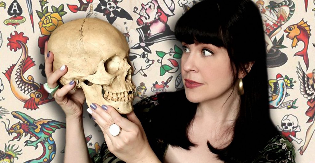 Headshot image of Caitlin Doughty holding a skull and looking at it as if in conversation.