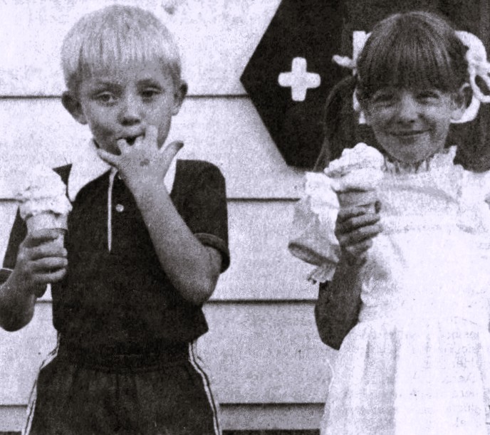 Two children eat ice cream cones.