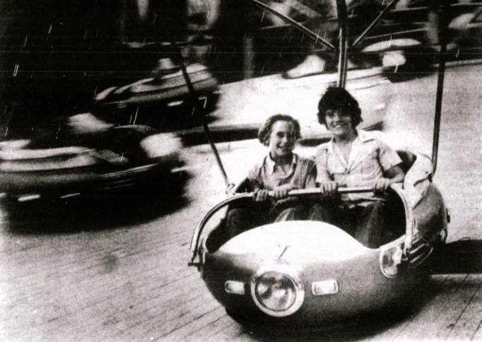 Two boys enjoy a carnival ride.