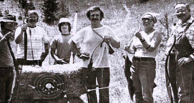 6 archers pose with their bows.