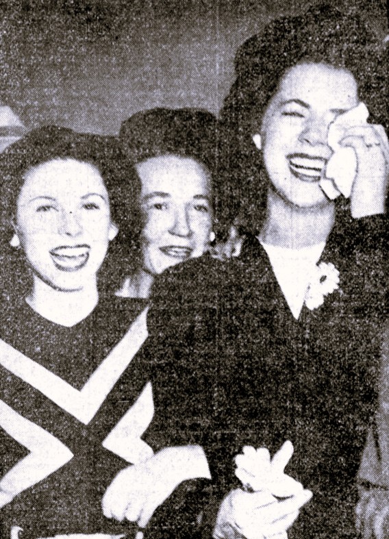 Three women react to the news of the end of World War II.