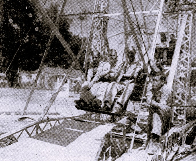 Three WWII servicemen ride a Ferris wheel.