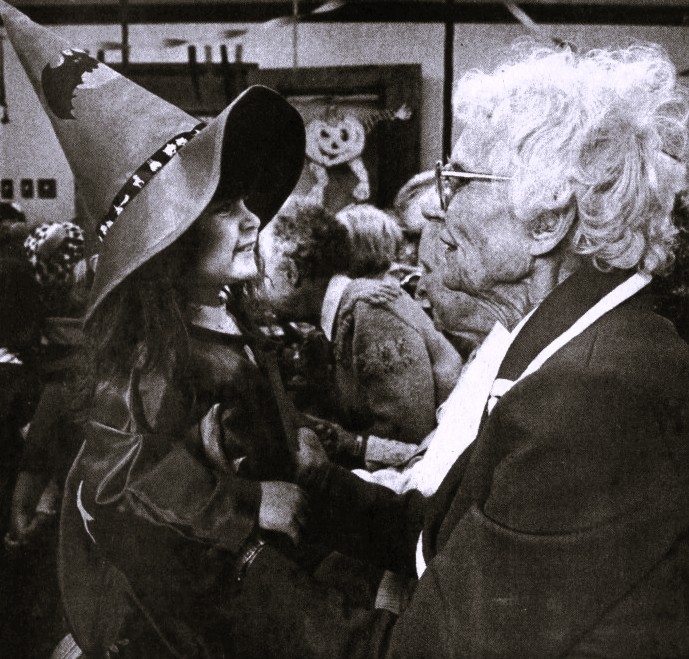 A girl dressed as a witch visits a woman in a nursing home.
