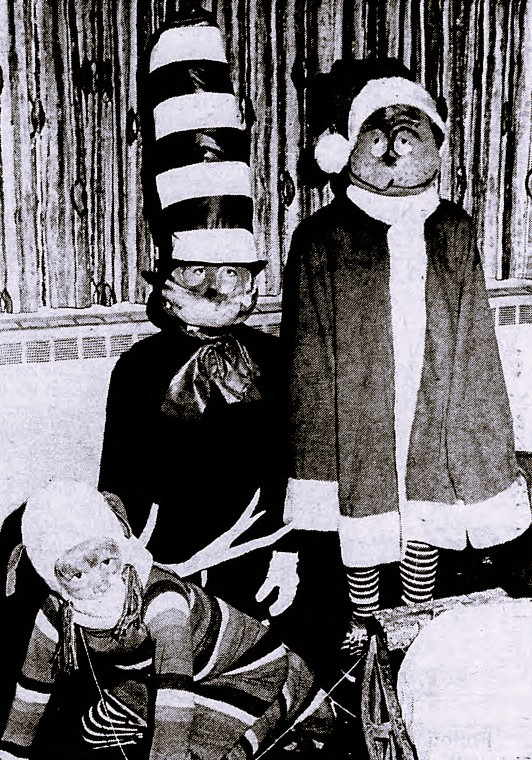 Three children wear costumes of Dr. Seuss characters.