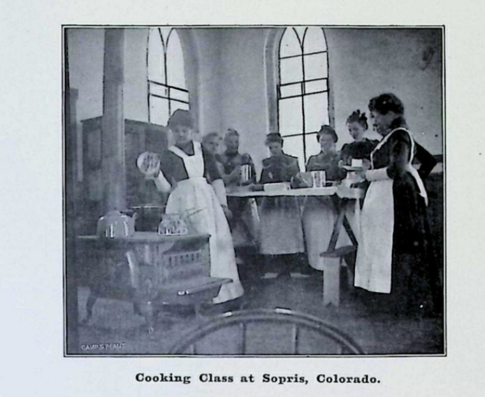 women in white aprons in cooking class; link to article in CHNC.org