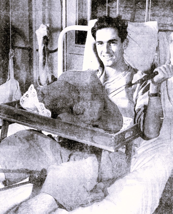 A hospitalized soldier prepares to carve a turkey.