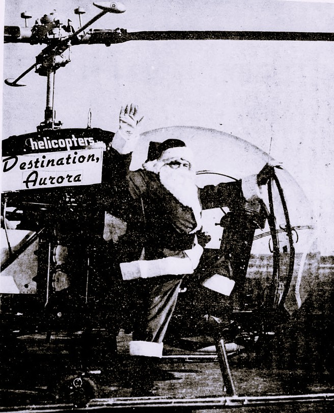 Santa Claus waves from a helicopter.