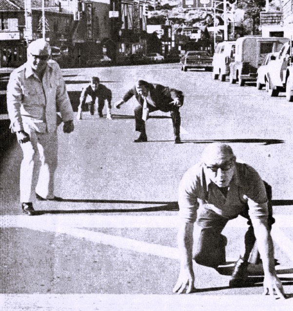 Four businessmen line up for a foot race.