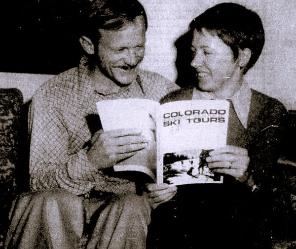 A husband and wife hold the book they wrote.
