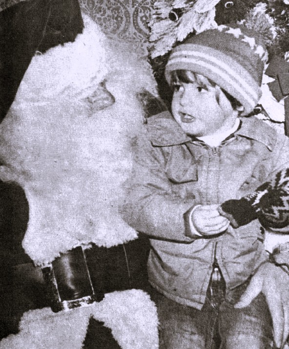 A child sits on Santa's lap.