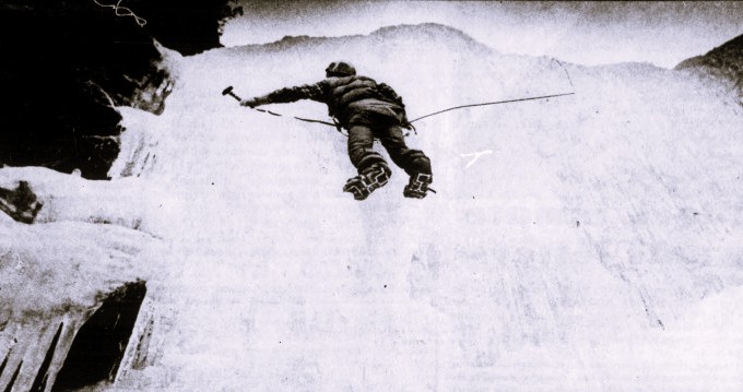 An ice climber uses a rope and axe.
