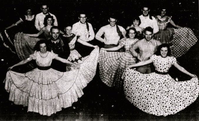 14 square dancers pose in formation.