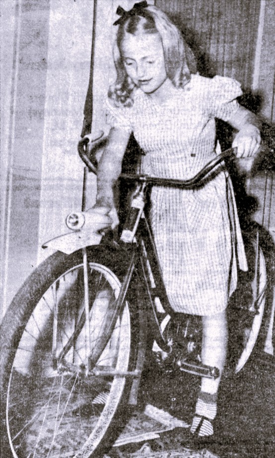 A girl sits on her new bike.