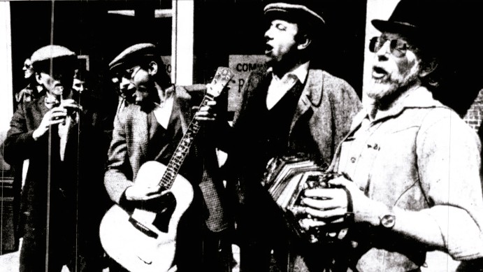 Four men perform traditional Irish music.