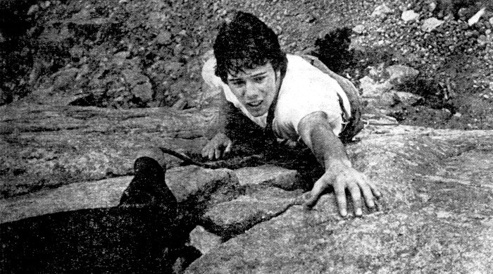 A man climbs a rock face.
