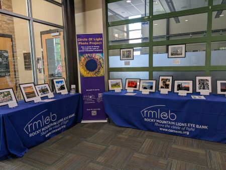 Two tables display framed photographs.
