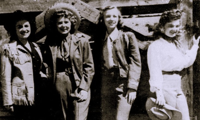 Four young women pose in Western wear.