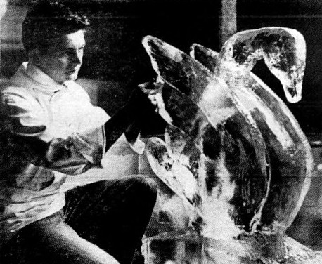 A man creates a swan ice sculpture.