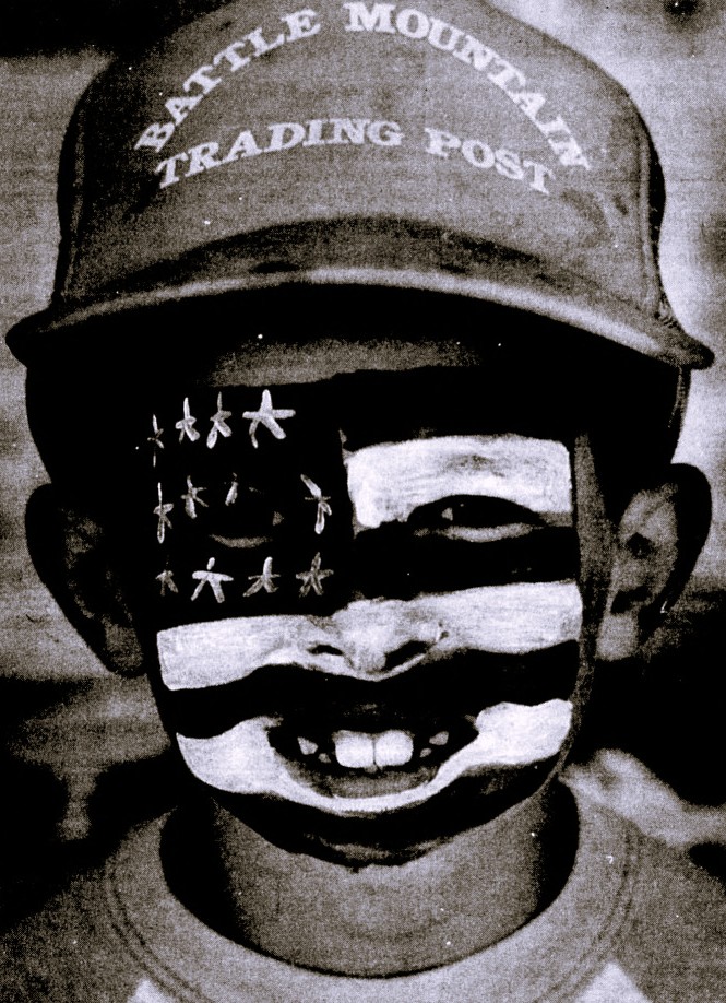 A boy's face is painted like the U.S. flag.