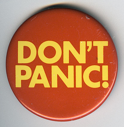 Round pin-on button with large words "Don't Panic"