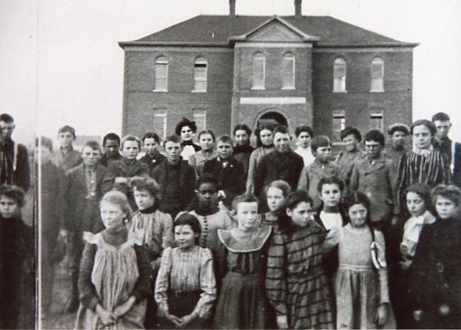 Children of all ages pose in front of Arvada School, which later became Lawrence Elementary after Arvada High School was built.
