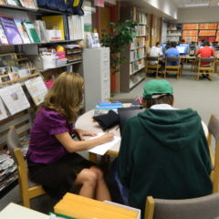 librarian and patron sitting at a table together