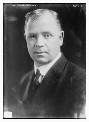A black and white photographic portrait of the governor.