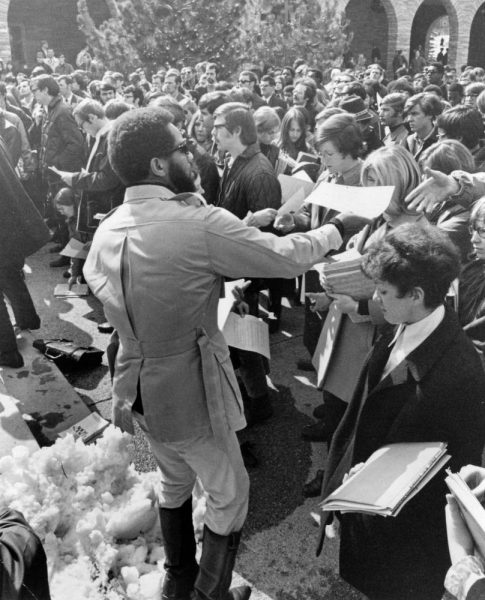 Lauren R. Watson (Yusef Karouma), an African American and member of the Black Panther Party, hands flyers to a crowd at the University of Colorado at Boulder.