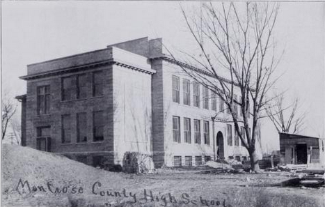 black and white photo of three-storey brick building