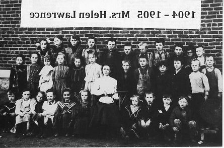 A class photo of first grade students from Arvada School and their teacher, Helen Lawrence.