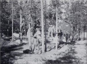 black and white photo of children amongst trees
