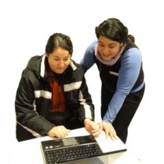 librarian helping a patron use her laptop