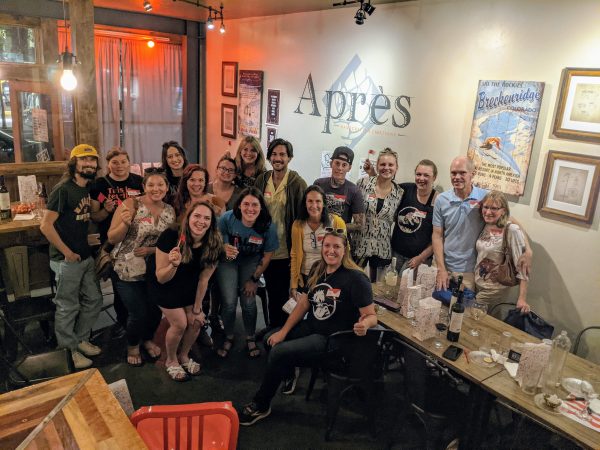 Group of adults posing for photo in a bar or restaurant 