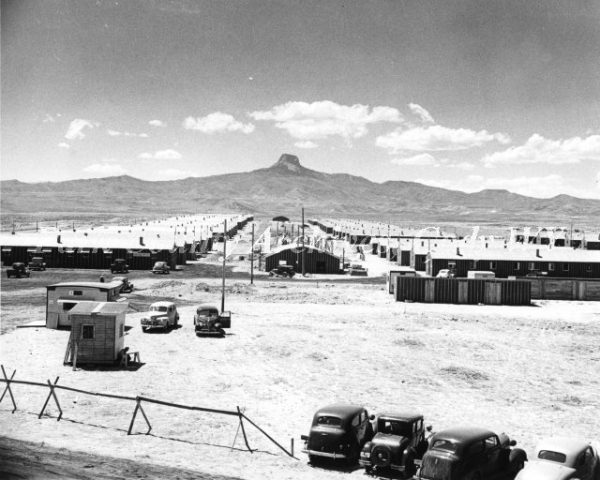 rows of housing units and desert butte in background