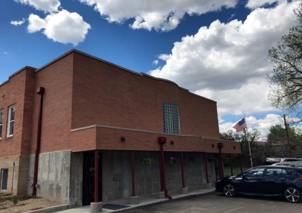 The front of the Wetmore Community Library, featuring brick and concrete construction, along with an American flag.