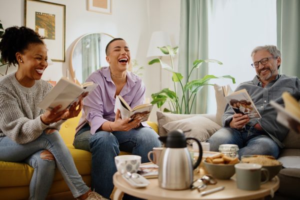 Small group of people with a mixed age range talking during a book club meeting.