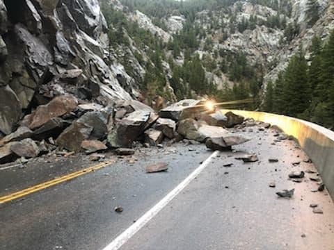 Fallen rocks block a mountain highway