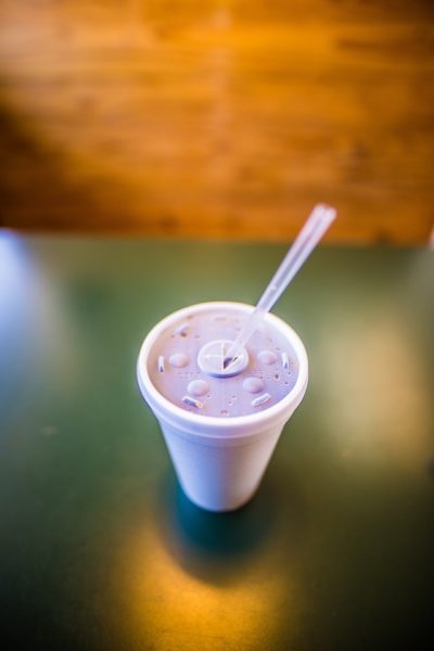 styrofoam cup with plastic straw