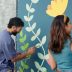 people painting on wall for art project