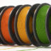 Various spools of colorful filament are neatly arranged, showcasing vibrant options for enthusiasts involved in 3D printing projects and crafts.